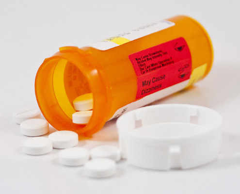 prescription medication bottle with pills fallen out